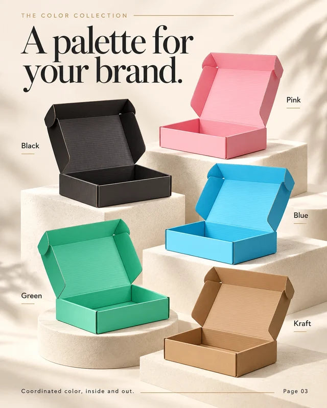 Open mailer boxes in black, pink, blue, green and natural kraft displayed on cream platforms