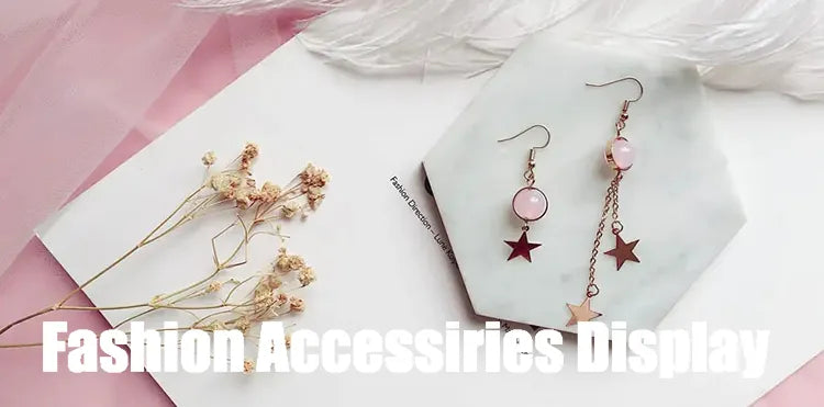 Fine jewelry display setting with earrings and necklace on presentation surfaces