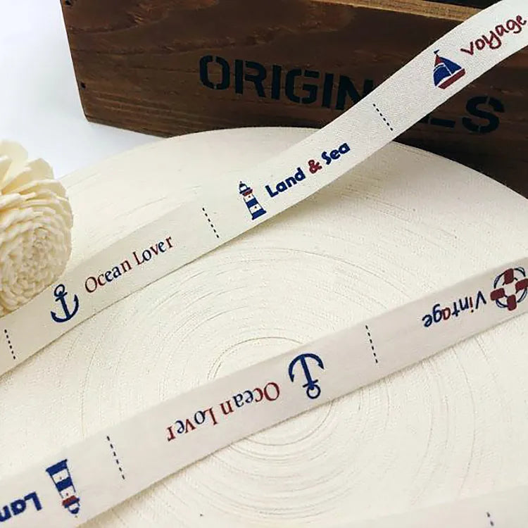 Cream cotton tape roll featuring custom nautical prints and logo patterns for garment trim