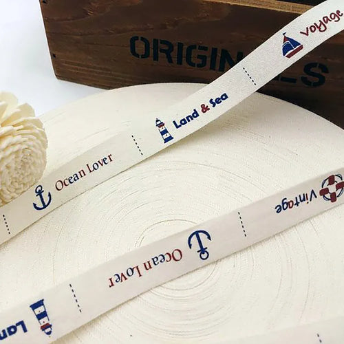 Cream cotton tape roll featuring custom nautical prints and logo patterns for garment trim