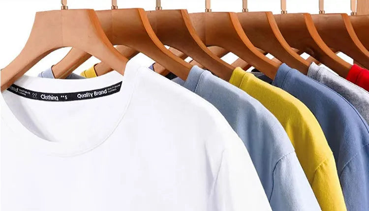 T-shirts displayed on hangers showing custom printed cotton tape applied along the interior neckline collar