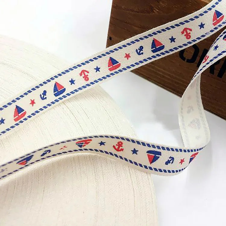 Continuous cotton tape roll featuring printed nautical motifs, rope borders, and star accents