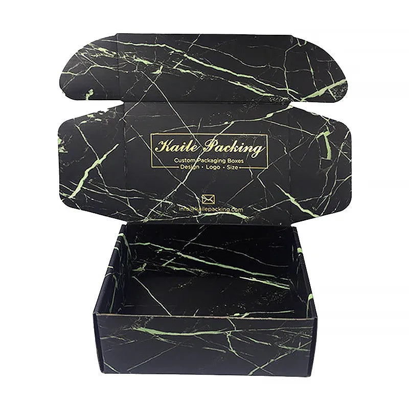 Open black mailer box printed inside and outside with green marble-style veins and gold-colored branding
