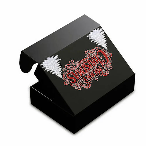 Black mailer gift box with red Merry Christmas lettering and white Christmas tree graphics on the lid