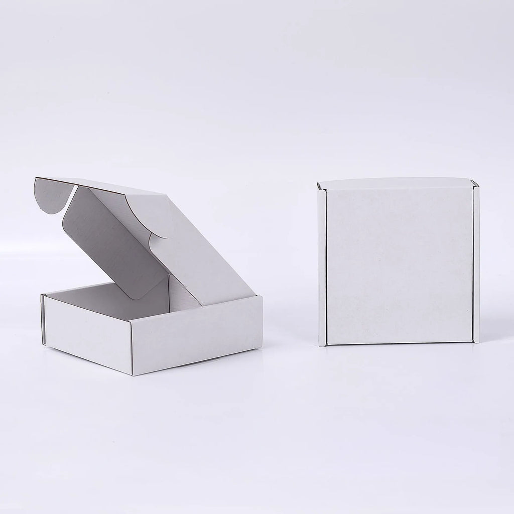 Open and closed plain white mailer boxes on a white background