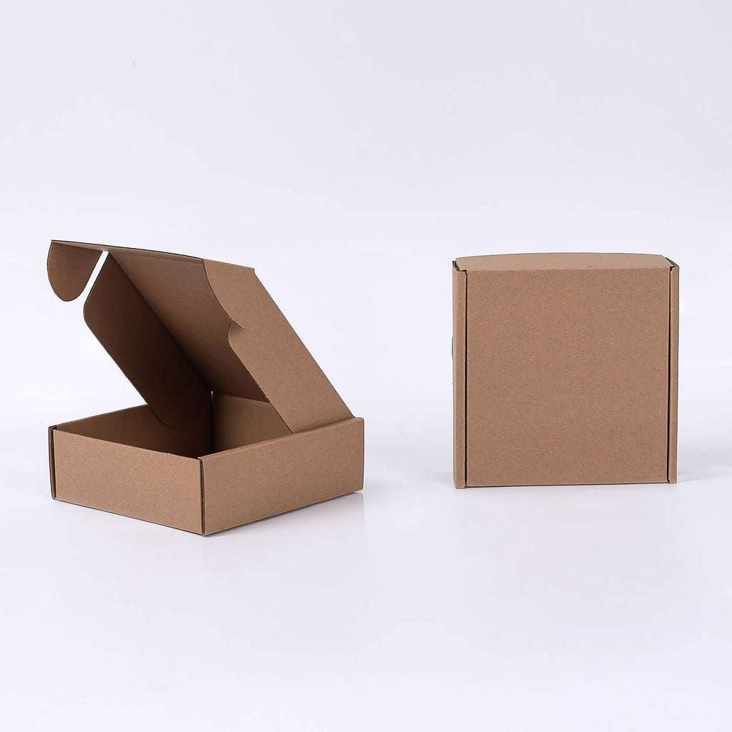 Open and closed plain brown kraft mailer boxes on a white background