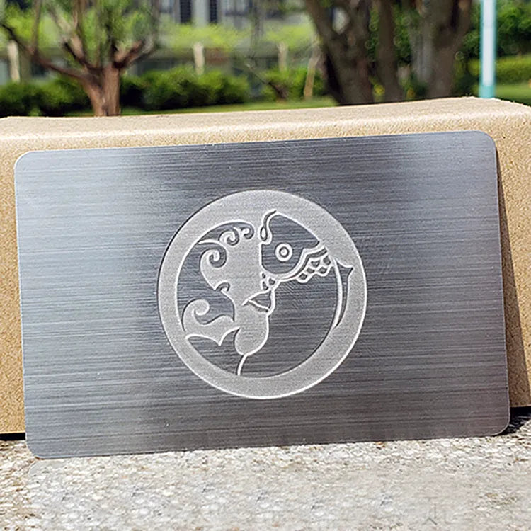 Brushed silver-tone metal card with a circular globe logo