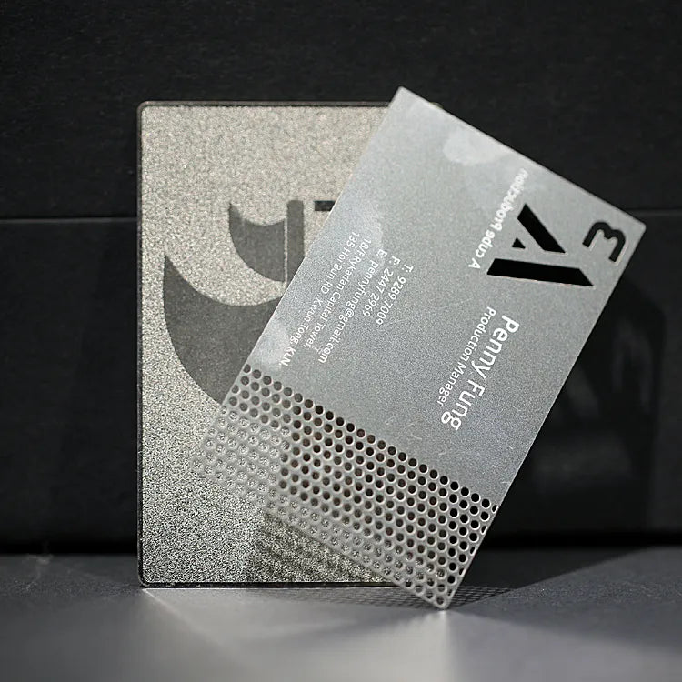 Silver-tone metal card with openwork cutouts and angular decorative shapes