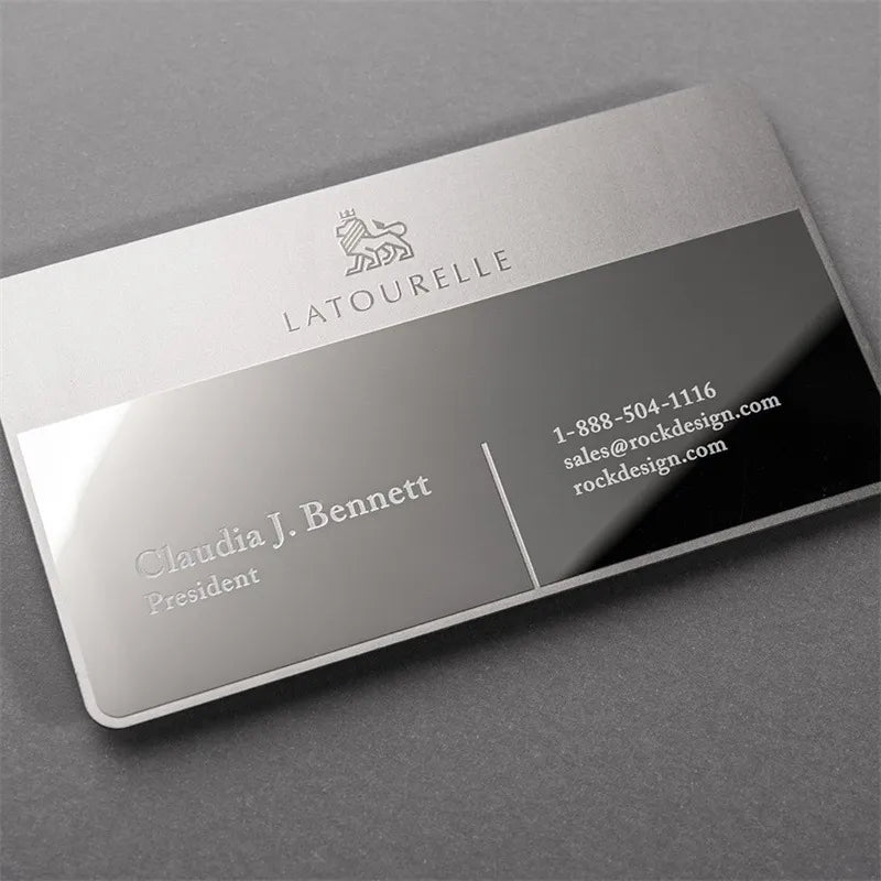 Silver-tone metal business card with a black diagonal design and light contact lettering