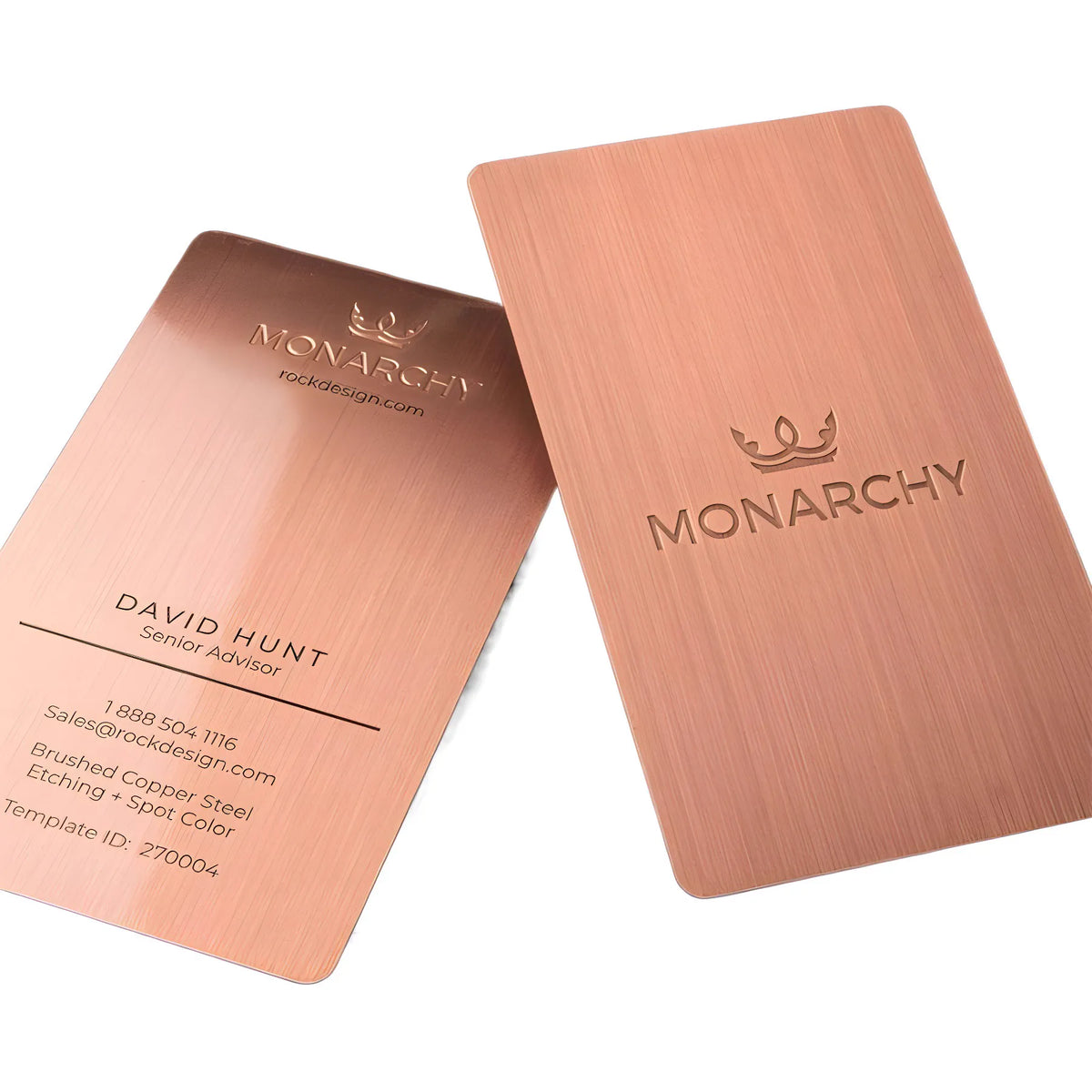 Two rose-gold-tone metal business cards with centered brand lettering on a pale background