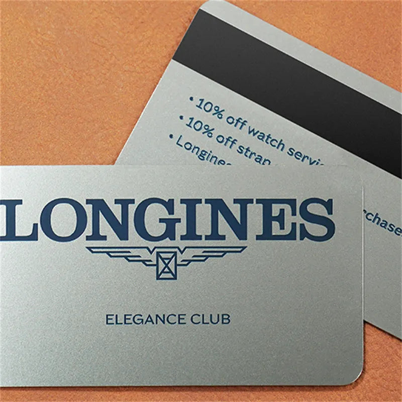Silver-tone metal card with LONGINES lettering and a black stripe