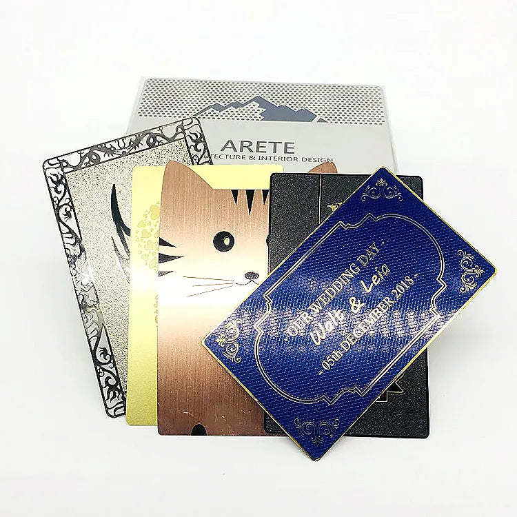 Metal business cards in silver, gold, rose-gold and blue tones with printed artwork