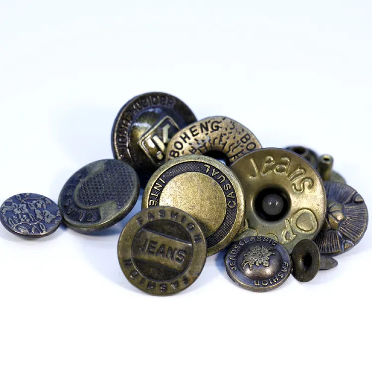Custom branded zinc alloy denim buttons featuring John Kleider JK logo with metal tack fasteners