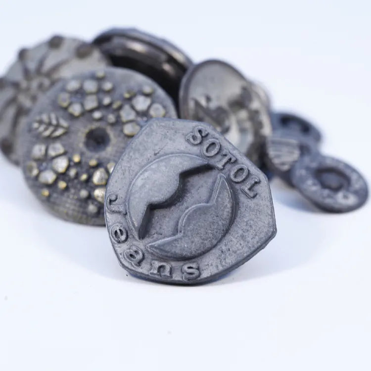Custom logo garment hardware set including vintage brass jeans buttons, snap fasteners, and square tack buttons