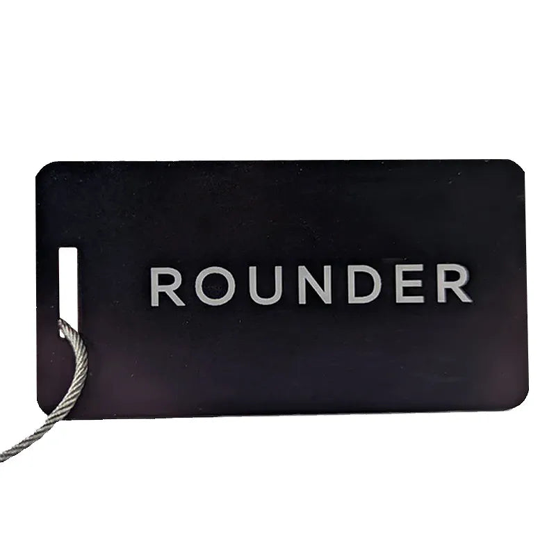 Black rectangular metal card with ROUNDER lettering and a small light-colored corner motif