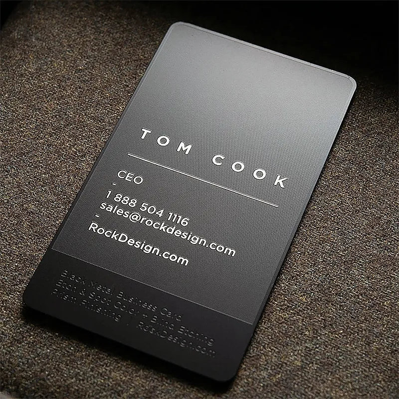Vertical dark metal business card with widely spaced lettering and fine contact details