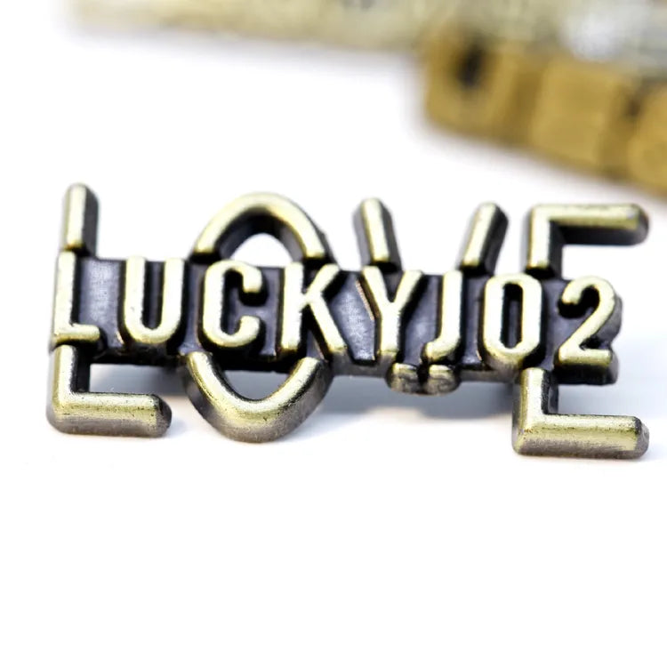 Antique brass-tone custom metal letter logo badge featuring 3D layered LUCKYJO2 wordmark over cutout LOVE monogram frame