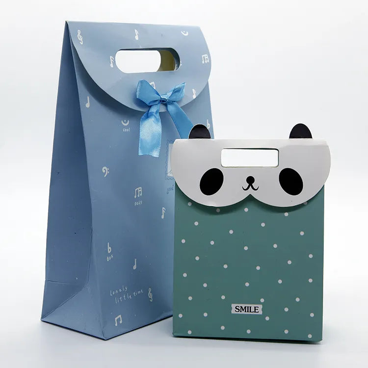 Blue and green paper gift bags with illustrated owl-face designs and die-cut handles