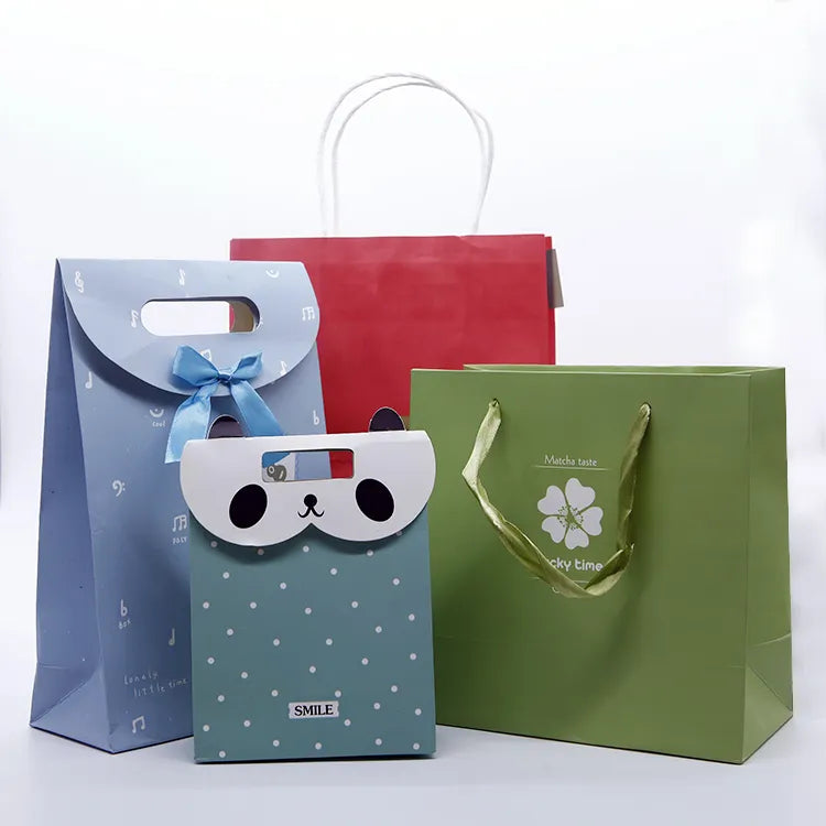 Colorful paper gift bags in several sizes with illustrated face and emblem designs