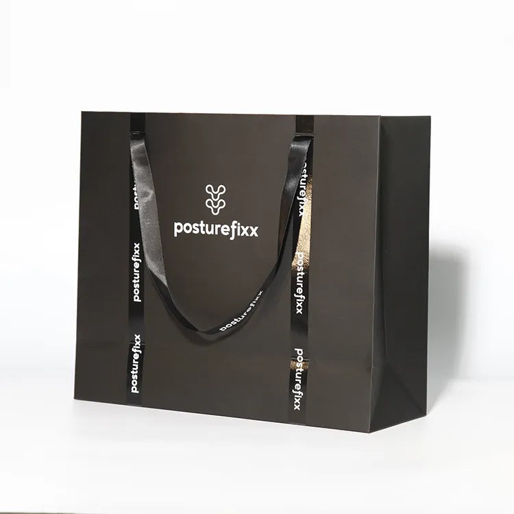 Dark paper carrier bag with cord handles and printed logo lettering