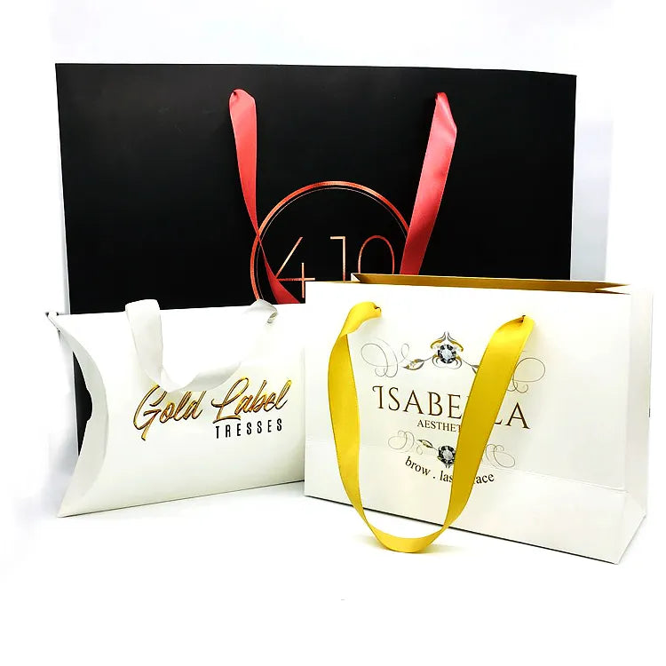 Black and white shaped paper gift bags with contrasting handles and printed logos