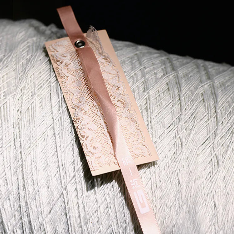 Long narrow pink paper hang tags attached with matching ribbon