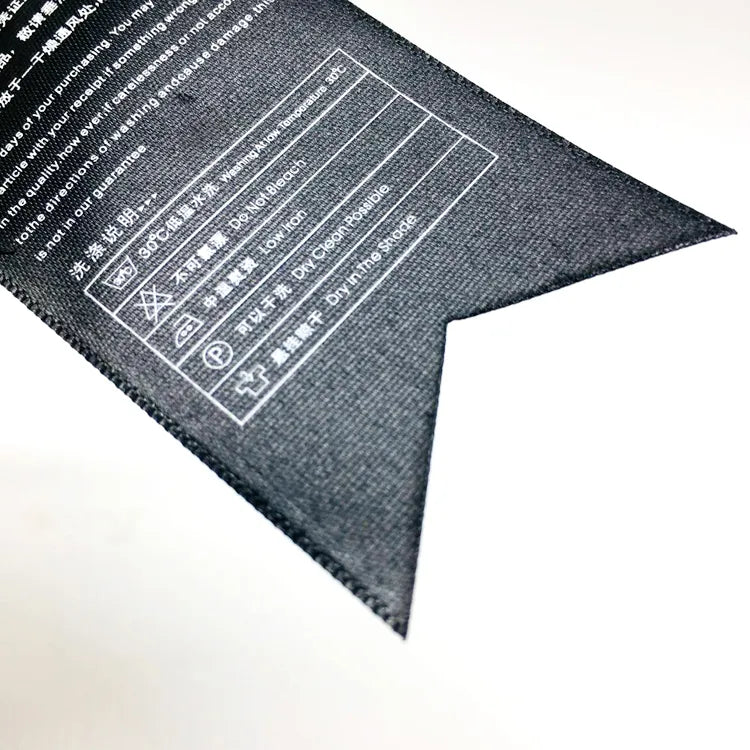 Folded black paper tag showing printed product information on the reverse