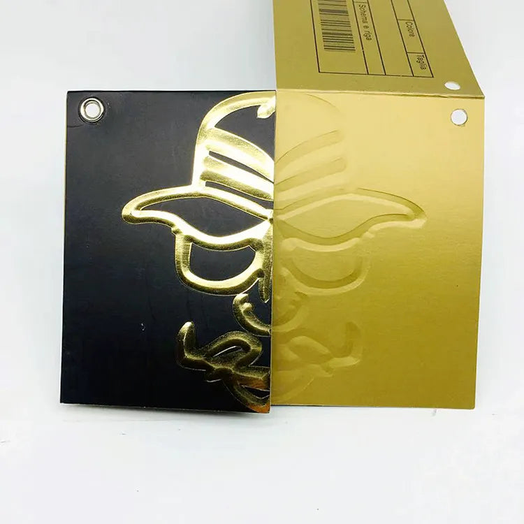 Black and gold hang tag samples showing decorative recessed lettering