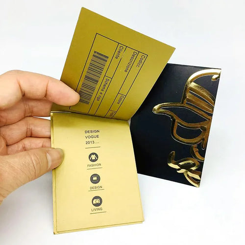 Folded gold and black paper tag with printed inner information panels