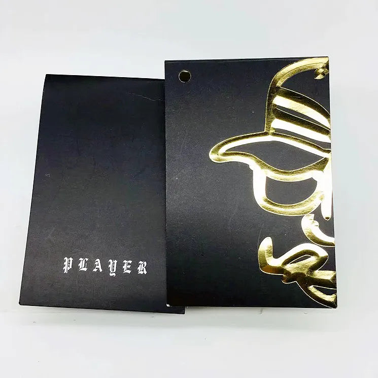 Black hang tag samples with metallic gold decorative lettering