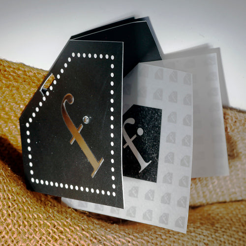 Custom Die-Cut Black Glitter Hang Tag - Pentagon black glitter card with white dot border, gold foil initial and frosted translucent overlay