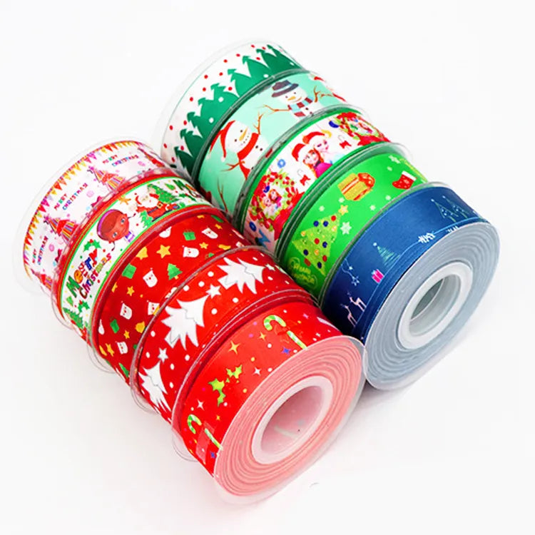 Stack of festive cartoon printed holiday ribbon rolls for seasonal gift wrapping and decor
