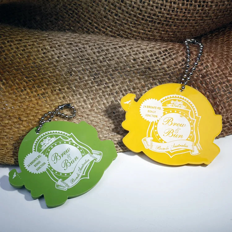 Green and yellow shaped rubber logo patches with contrasting raised details