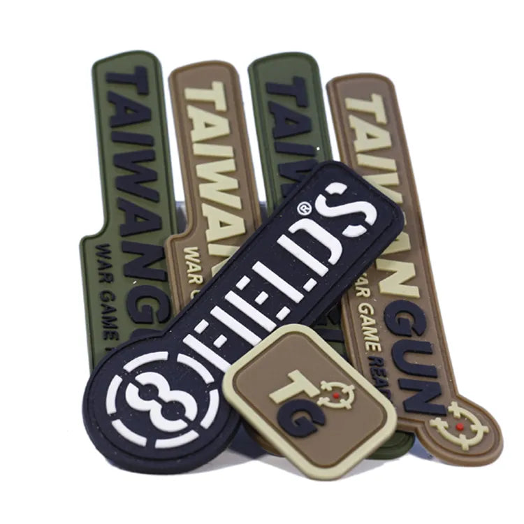 Assortment of custom tactical PVC rubber morale patches with raised lettering and target emblem designs