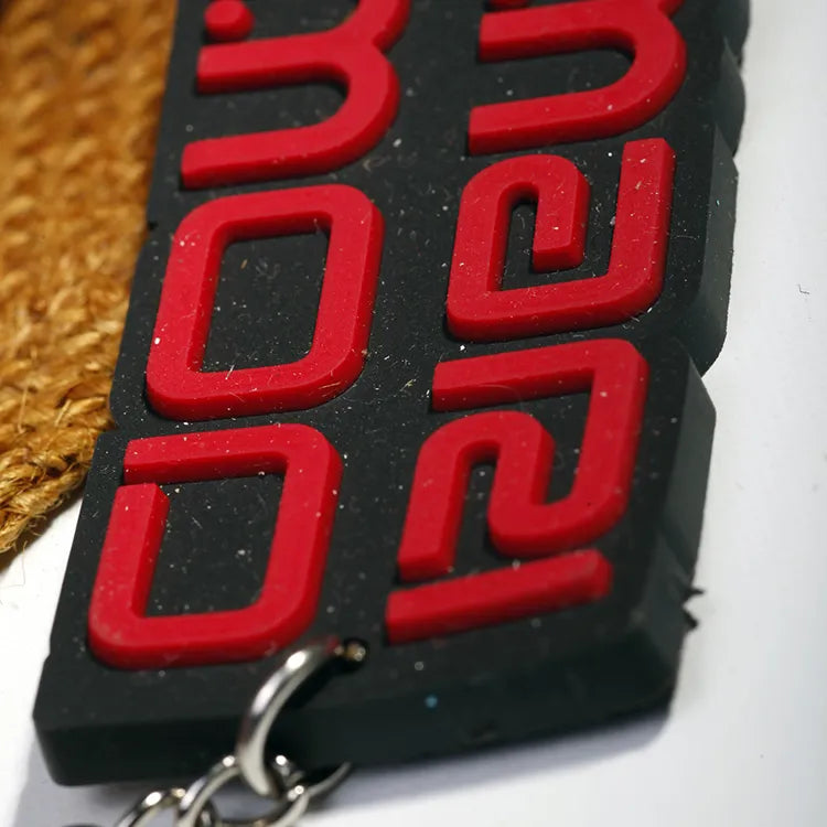 Assorted custom shaped rubber badge samples with colorful raised artwork