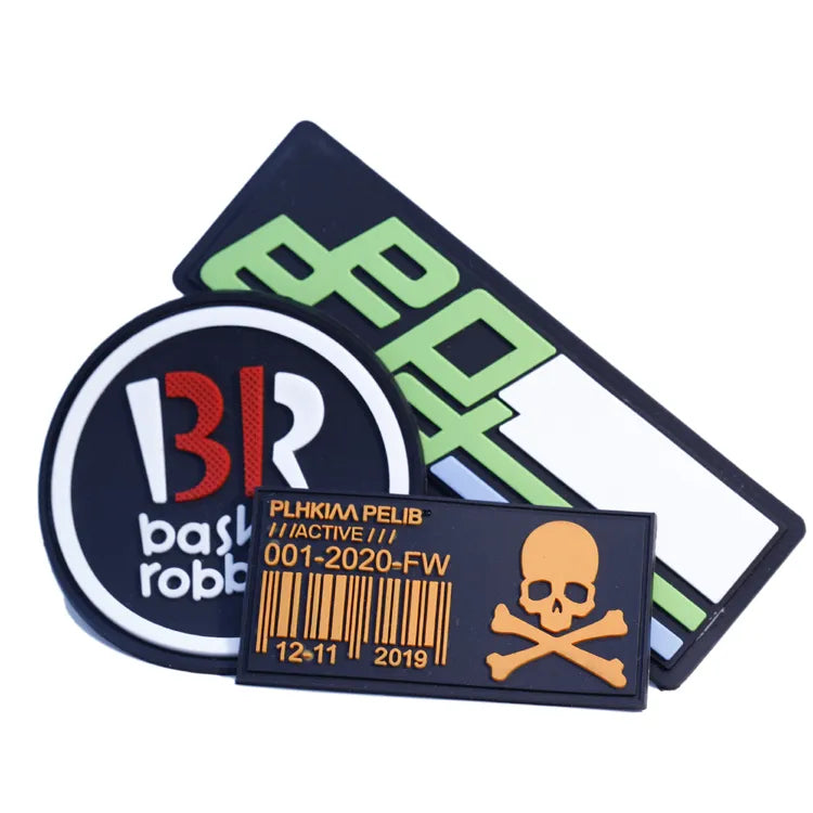 Assorted rectangular and round brand logo patches with raised details