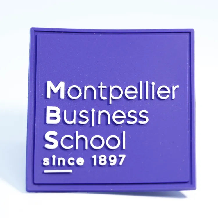Custom purple PVC rubber school logo patch with raised lettering for Montpellier Business School