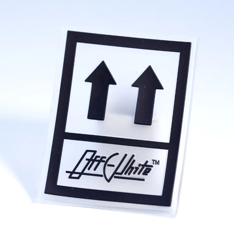 Custom black and white PVC rubber packaging label with upward arrows and raised brand logo