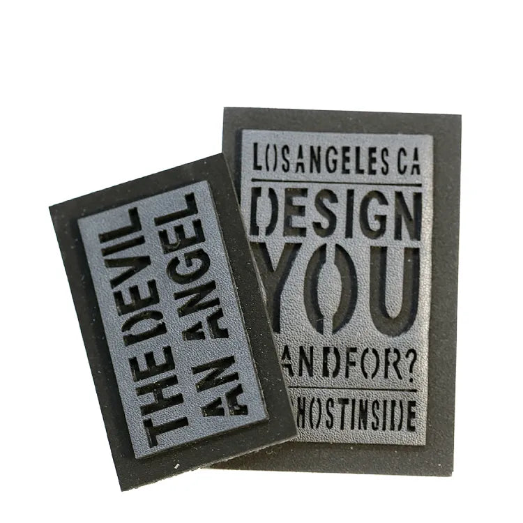 Rectangular dark logo patches with recessed typography and bordered edges