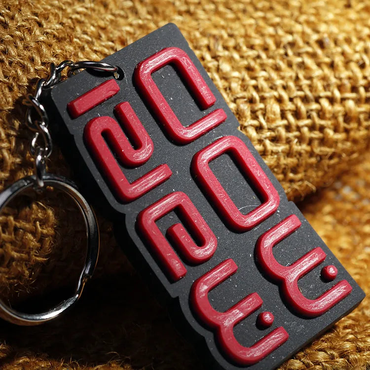 Close-up of red raised lettering on black rectangular rubber brand patches