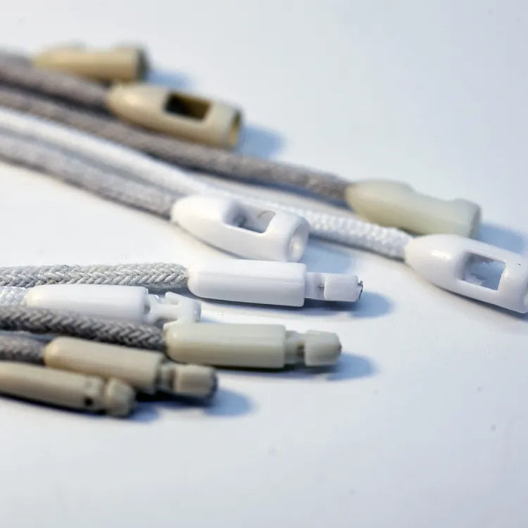 Braided hang tag strings with white plastic barrel cord locks