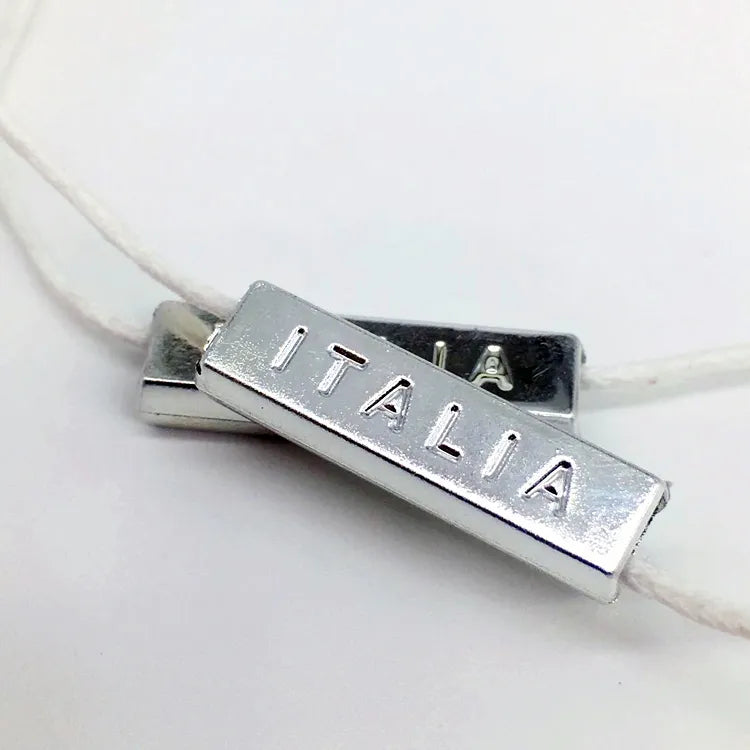 Silver-tone metal bar beads on white cord
