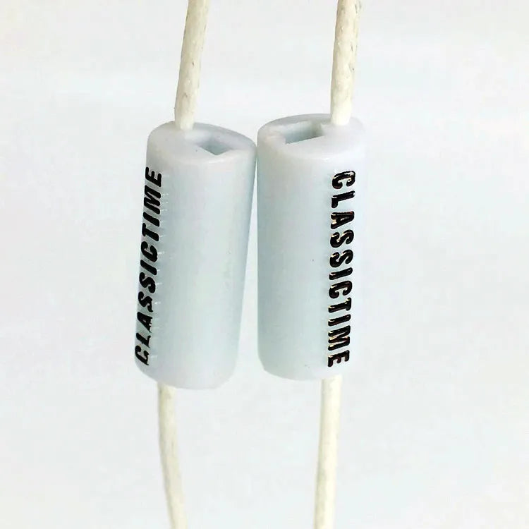 White cylindrical plastic cord locks with cords threaded through
