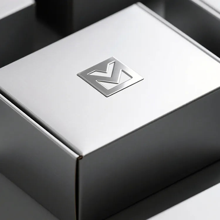 Silver-tone geometric logo centered on a white gift box lid