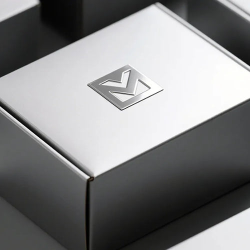 Silver-tone geometric logo centered on a white gift box lid