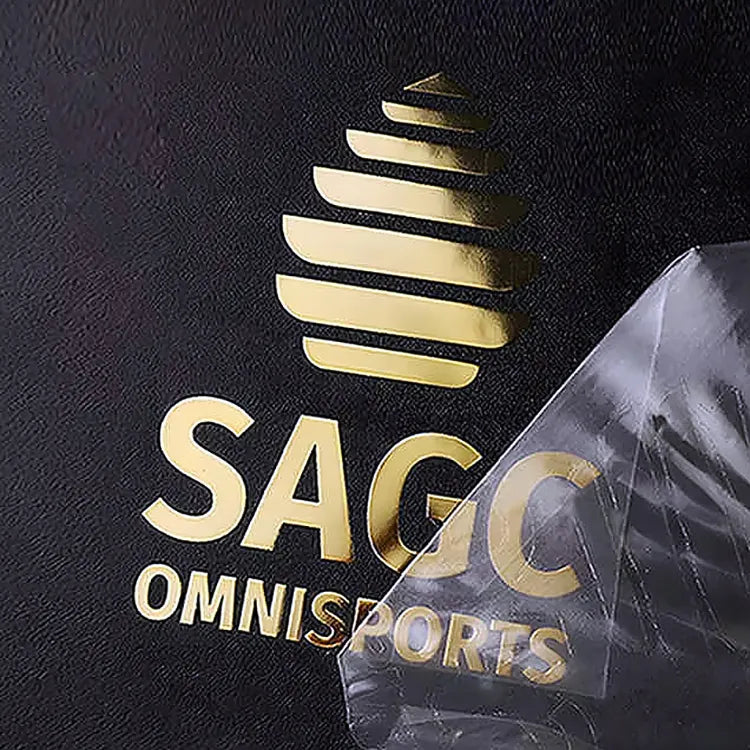 Gold-tone logo lettering on a black finished surface with clear transfer film