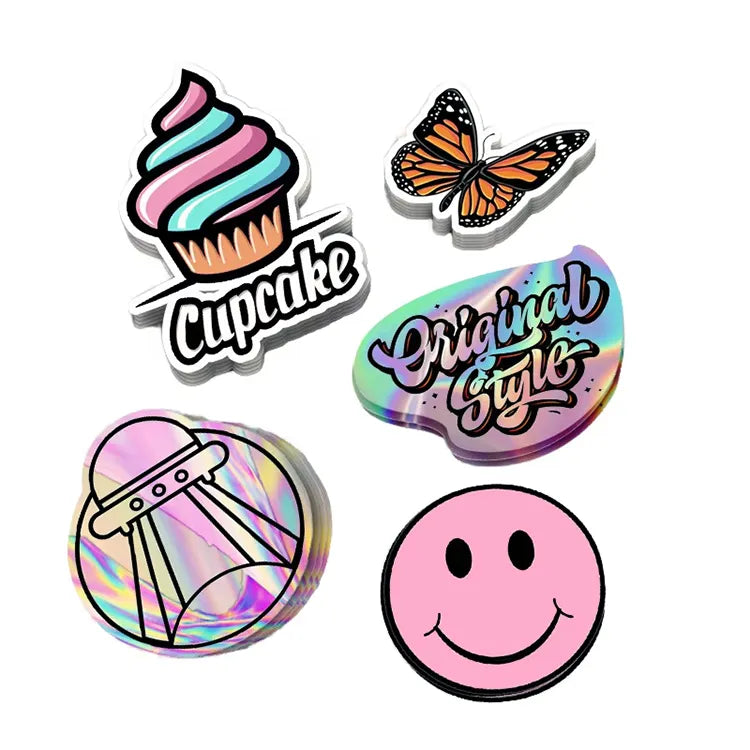 Assorted decorative sticker samples with cupcake, butterfly, lettering, UFO and smiley designs