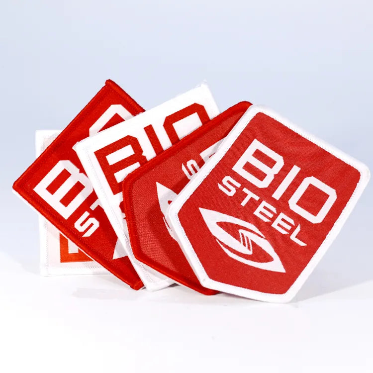 Custom red and white embroidered logo patches with geometric lettering and emblem