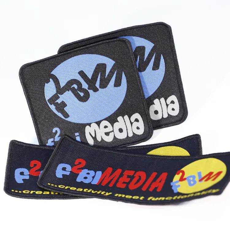 Set of colorful embroidered media logo patches with bold lettering and multicolor designs