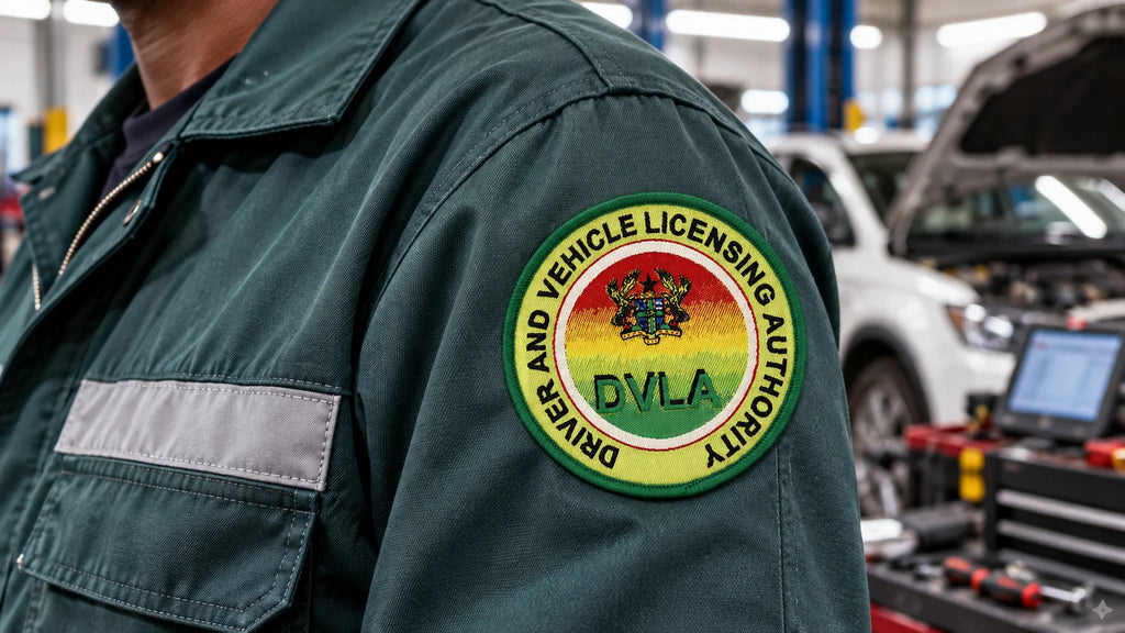 Custom embroidered DVLA patch sewn onto a work jacket in an automotive workshop